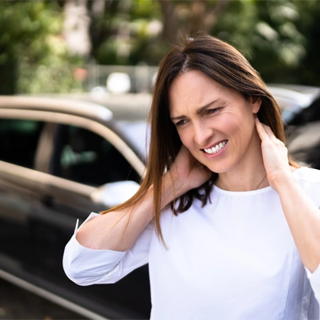Person Holding The Neck Near A Vehicle Following A Motor Vehicle Accident